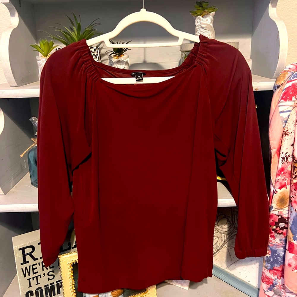 Maroon lightweight women’s blouse, 60% rayon/40% polyester. Machine washable.